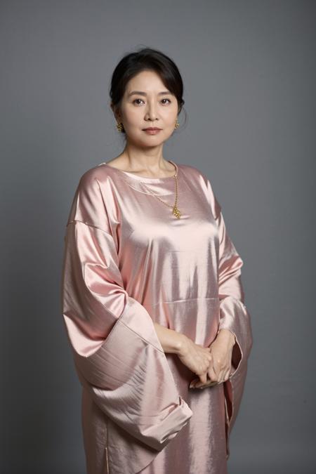 11169-489540977-upper body of asian female 60 years old,Wearing luxurious clothing,standing in front of a simple background,studio,.png